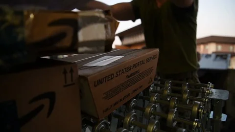 Military postal workers loading parcels onto conveyor Stock Footage 122211379