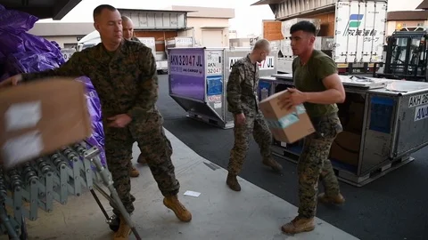 Military postal workers loading parcels onto conveyor belt Stock-Footage 122238250