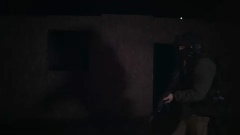 Military soldier changes location in the dark Stock Footage 171964643