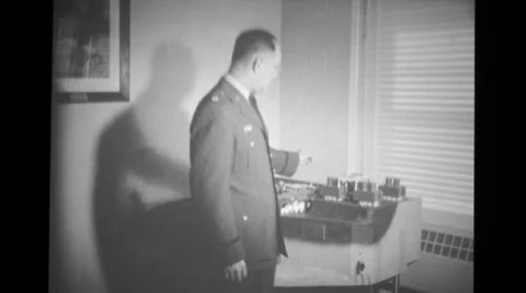 Military soldier pointing out various parts of scale model of PM-1 plant Stock Footage