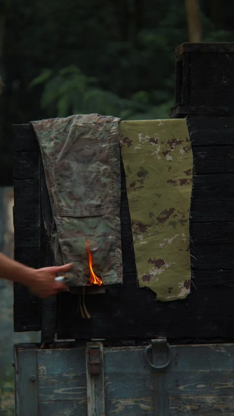 Military Soldier Testing Flame-Resistant Tactical Fabric with Portable Gas Burne Video stock 337830161