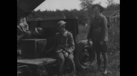 Military soldiers adjusting sound locator machine in military land vehicle Stock Footage
