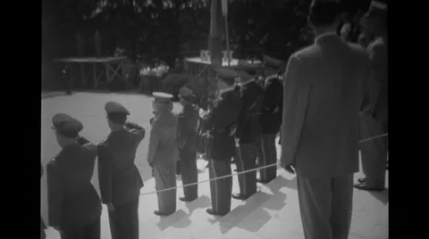 Military soldiers and officers standing in a row and saluting near a tomb Stock Footage