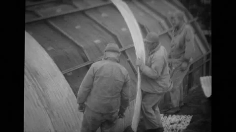 Military soldiers building quonset hut Stock Footage