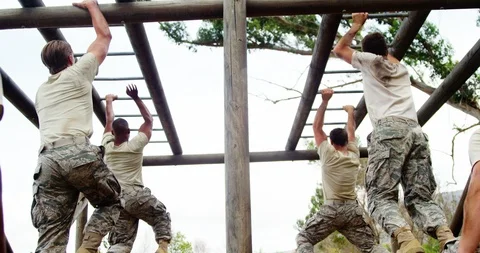 Military soldiers climbing monkey bars 4... | Stock Video | Pond5