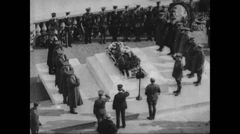 Military soldiers gathered around tomb at the funeral and saluting Stock Footage