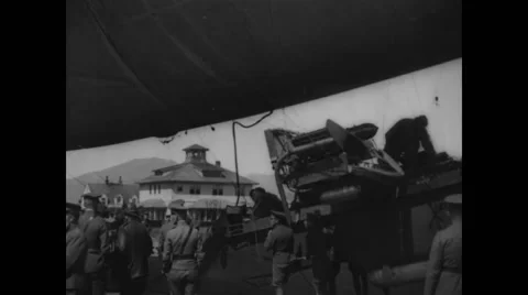 Military soldiers holding gondola of C-2 class army blimp at Crissy Field Stock Footage