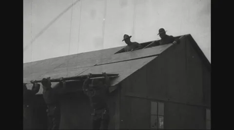 Military soldiers installing roof panels Stock Footage