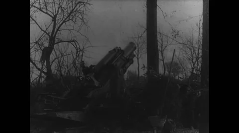Military soldiers loading gun into artillery and firing during war Stock Footage