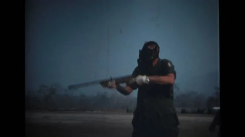 Military soldiers shooting with a rifle and walking Stock Footage