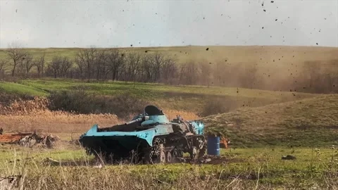 Military tank strikes a target which explodes and scatters debris Stock Footage 313255485