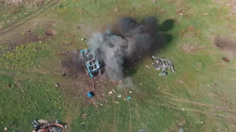 Military tank strikes a target which explodes and scatters debris Stock Footage 313255499