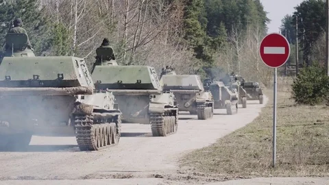 Military tanks driving along the road, military convoy Stock Footage