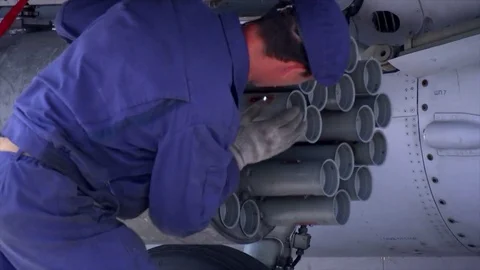 Military technical serviceman charging a fighter gun with armed shells Stock Footage 73480300