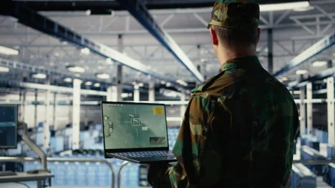 Military technician in data center tracking satellite coordinates using notebook Stock Footage 314803557