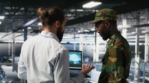 Military technicians in secure data center use laptop to monitor AI systems Stock Footage 310278378