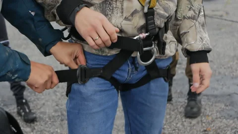 A military training instructor zips up training jumping equipment on a cadet Stock Footage 141791034