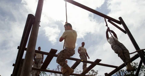 Military troops climbing rope during obstacle course 4k Stock Footage
