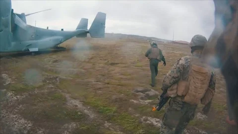Military troops loading helicopter from combat mission Stock Footage