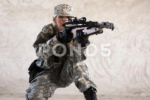 Military woman with crossbow Stock Photos