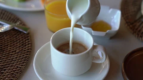 Milk is added to coffee at breakfast Stock Footage 261040503