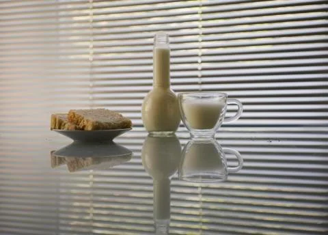 Milk and bread on a table on a background window Stock Photos