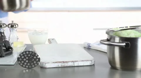 Milk and butter being added to a pot and potatoes being mashed 스톡 동영상 24658316