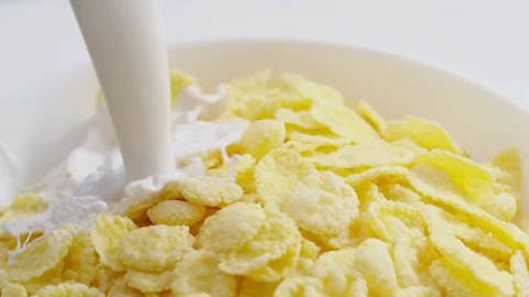 Milk and cornflakes throwing into the cereal bowl Stock Footage 171887936