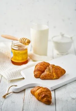 Milk and croissant on the rustic table Stock Photos