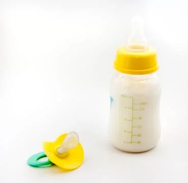 Milk and the pacifier Stockfoto's