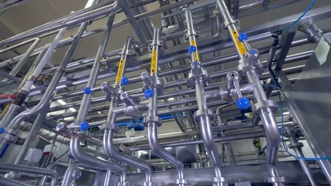 Milk and water pipelines at a dairy factory. Stock Footage