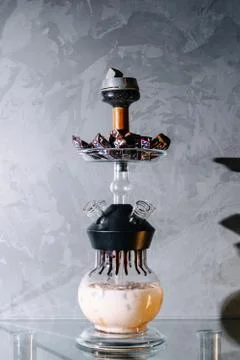Milk based cold shisha with snickers chocolate balls in a bowl, placed on gla Foto stock