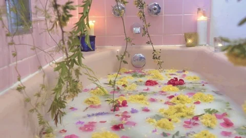 A Milk Bath with Flowers Floating on the Water in a Luxury Spa Stock Footage 74004460