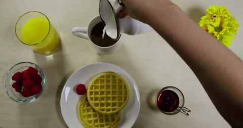 Milk Being Poured Into Coffee at Breakfast Stock Footage 243377228