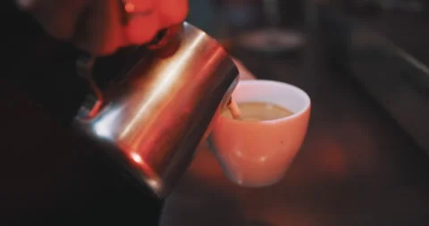 Milk being poured into coffee, making a pattern Stock Footage 203581826