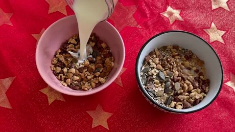 Milk Being Poured Over Breakfast Cereal and Seeds Stock Footage 344577502