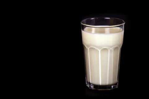 Milk on a black background. Stock Photos