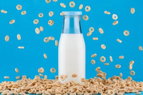 Milk bottle on blue background. Stock Photos