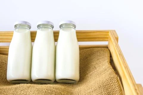 Milk bottle in the box Stock Photos