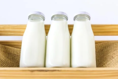 Milk bottle in the box Stock Photos