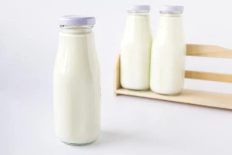 Milk bottle in the box Stock Photos