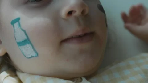 Milk bottle drawing on the face of a cute little girl. Agriculture concept Stock Footage 256038551