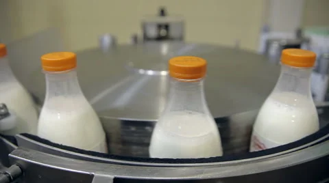 Milk bottles on the conveyor Stock Footage 64538411