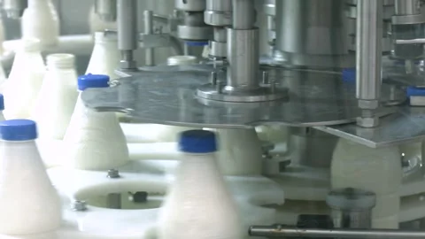 Milk bottles on industrial conveyor. Packaging bottles line in the milk industry Video stock 313225209