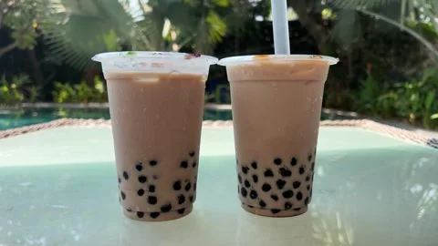 Milk bubble tea with tapioca pearls in glass, gray background. Two Bubble Tea Stock Footage 277644851