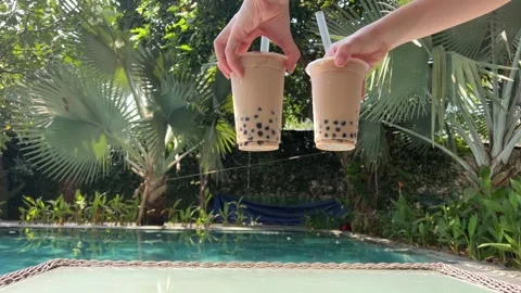 Milk bubble tea with tapioca pearls in glass, gray background. Two Bubble Tea Stock Footage 277644914