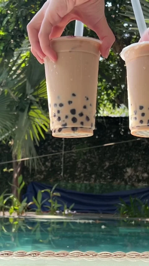 Milk bubble tea with tapioca pearls in glass, gray background. Two Bubble Tea Stock Footage 277678092