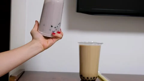 Milk bubble tea with tapioca pearls in glass, gray background. Stock Footage 291634247