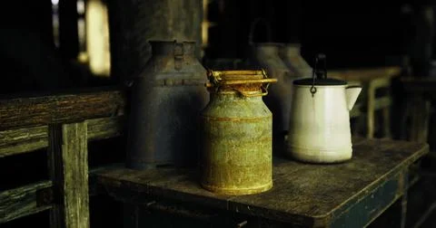 Milk cans and a pitcher on a rustic barn table Stock Illustration