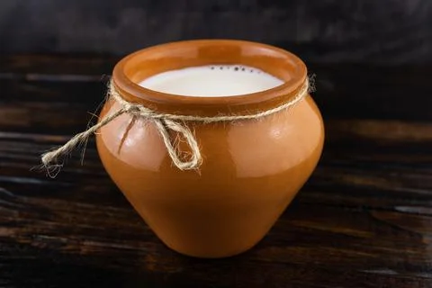 Milk in a ceramic jug Foto stock